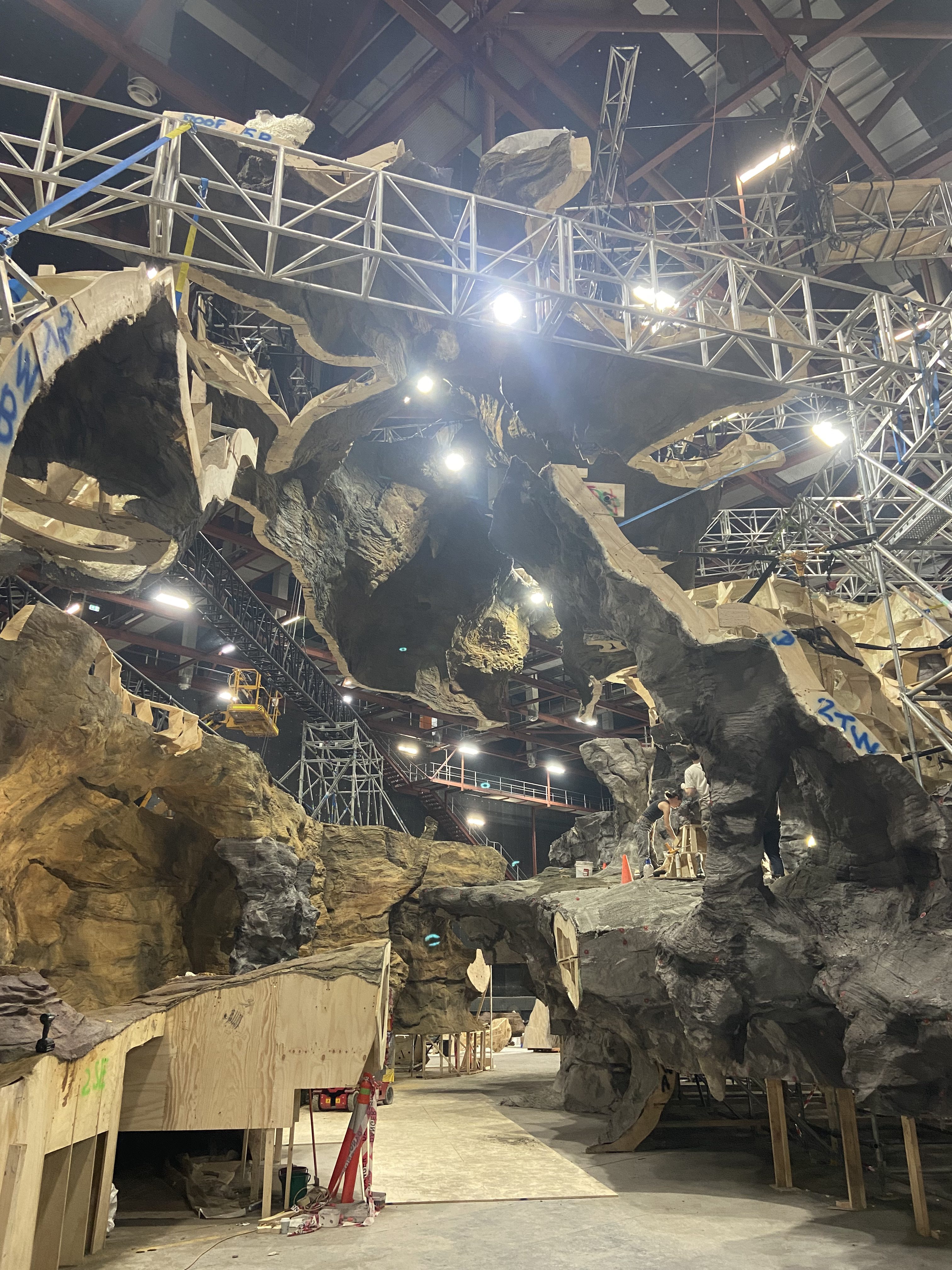 Interior of the cave build showing suspended rockwork, trusses and layered scenic construction.
